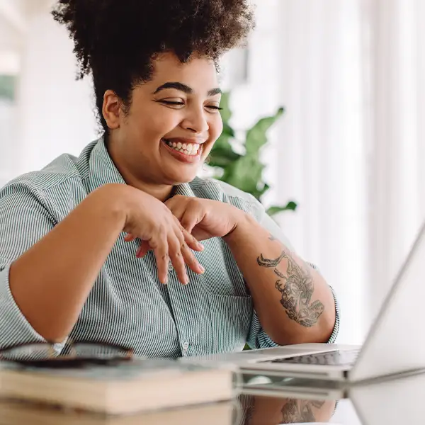 Woman smiling at laptop