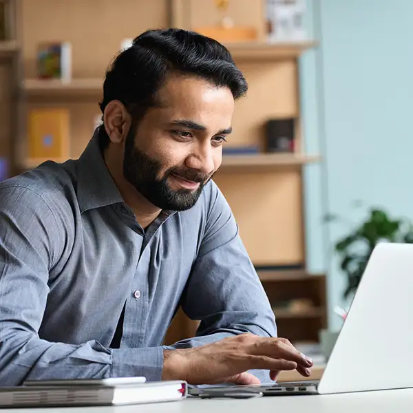 Man smiling at laptop